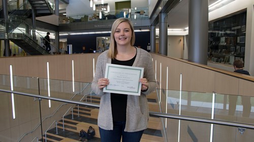 Mariah holding her certificate