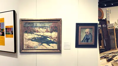 Artwork on display in the Gallery and Kevin Titzer speaking with students