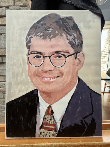 Painting of young President Bridges wearing a suit and tie