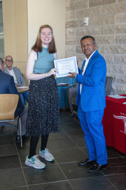 Sudesh handing Ereena a certificate