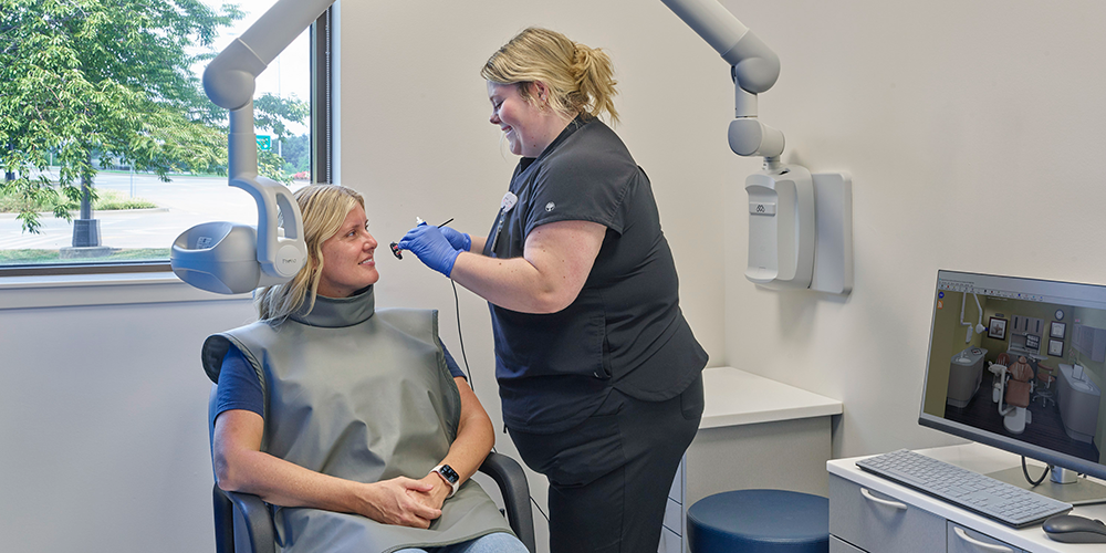 Student taking dental x-rays for patient in dental clinic