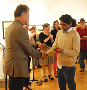 Man presenting prize to another man