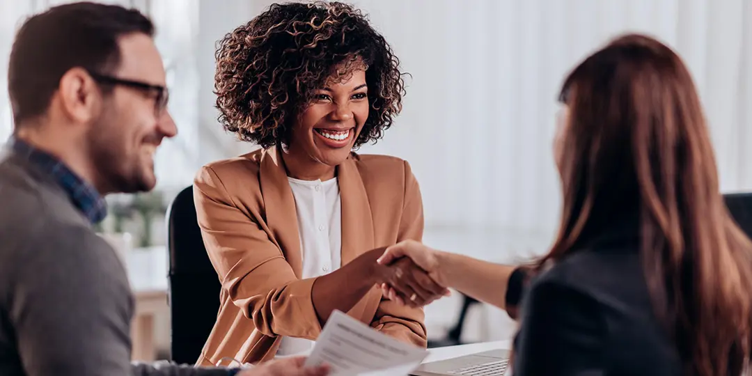 Business professionals shaking hands on a job offer
