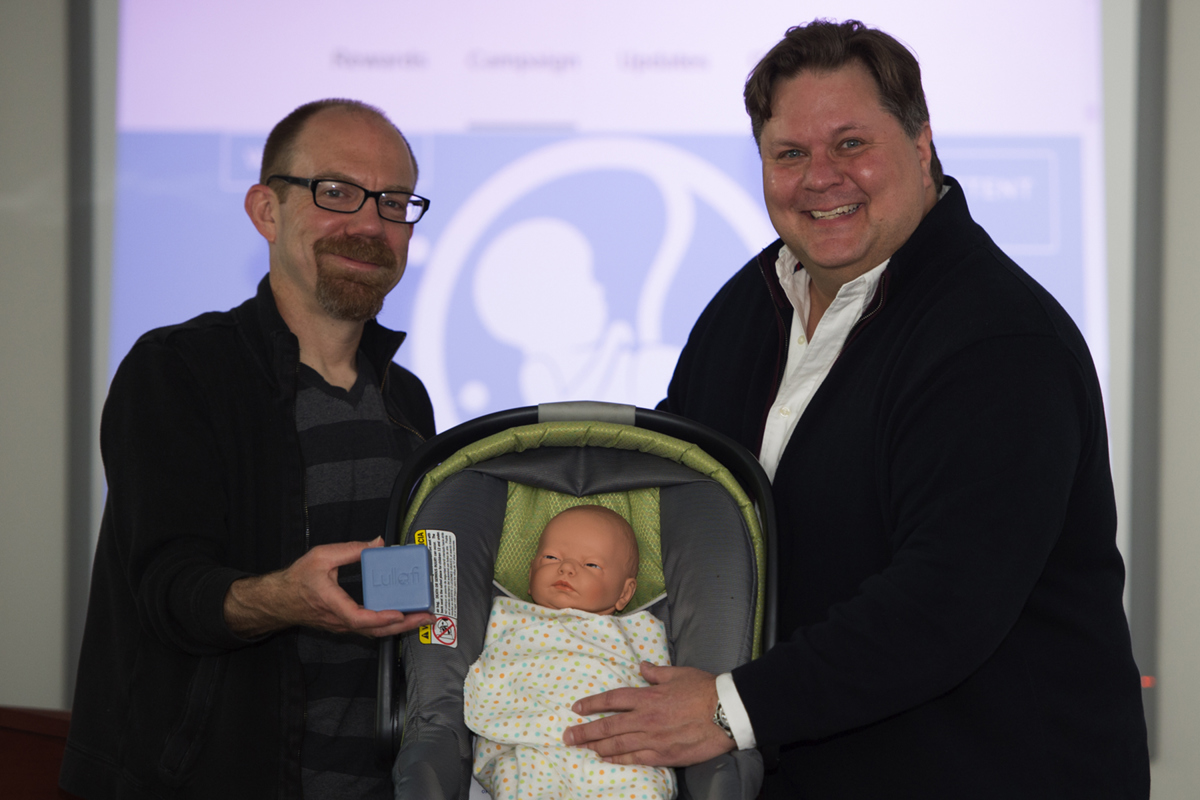 Mike Boren and Bryan Bourdeau, instructor in business, pose with Lullafi (in Boren's hand).