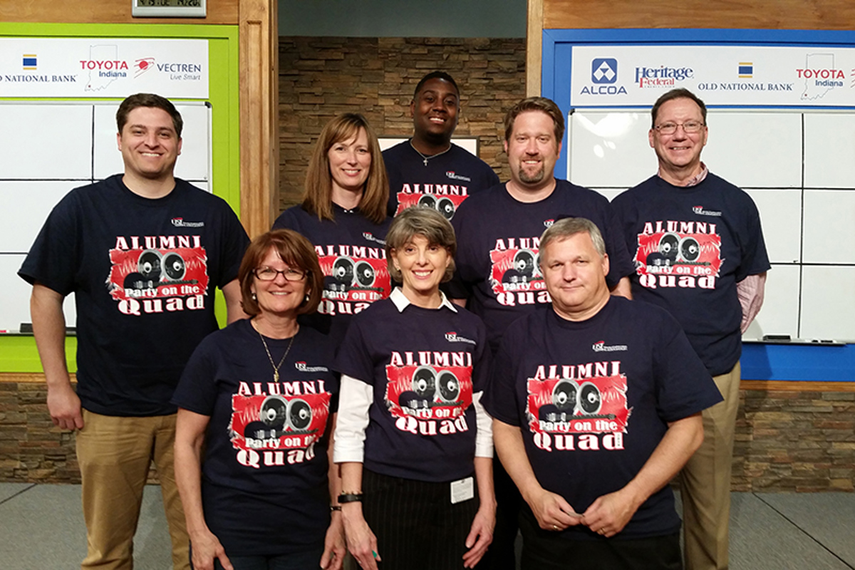 Members of the USI Alumni Association show off the 2016 Party on The Quad T-shirts.