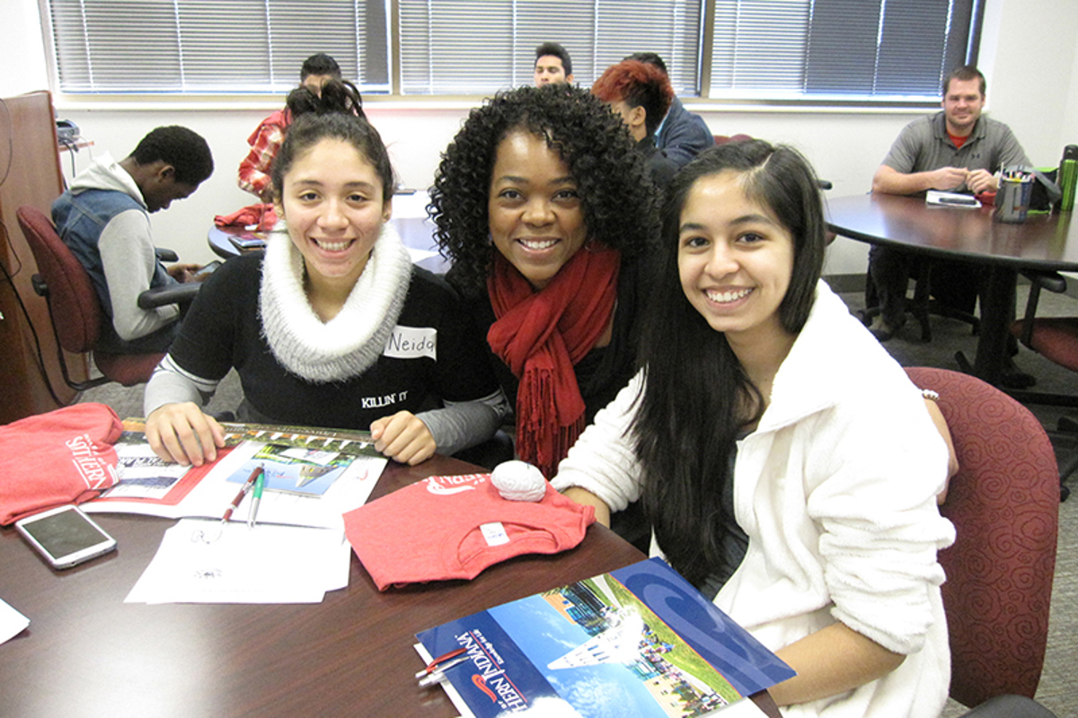 Kerseclia Patterson (center) working with students.