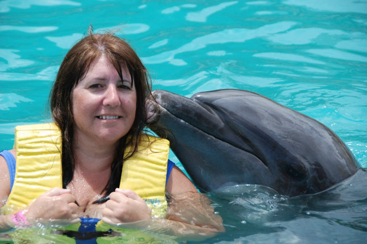Nita Musich getting some dolphin kisses.