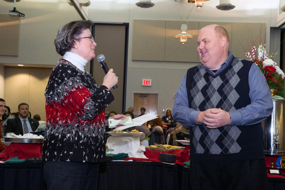 President Linda L.M. Bennett presents award to Dr. Darrin Sorrells
