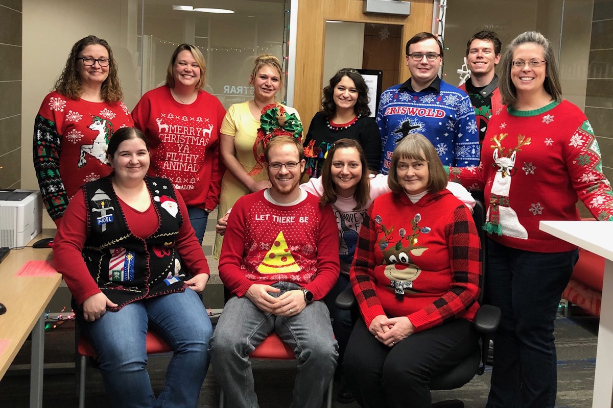 Registrar's Office staff show off their Ugly Holiday Sweaters. 