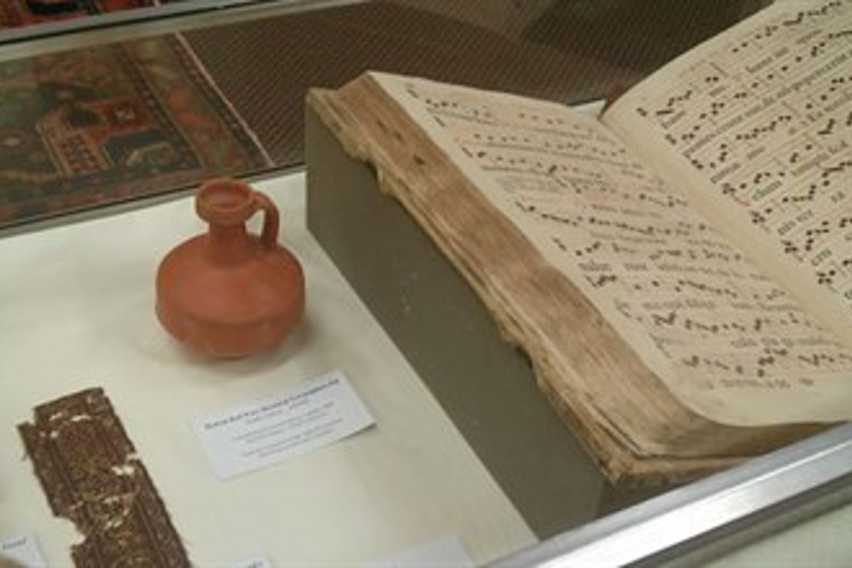 Several items, including a red clay jar believed to be circa 600 BCE, on display in USI's Lawrence Library