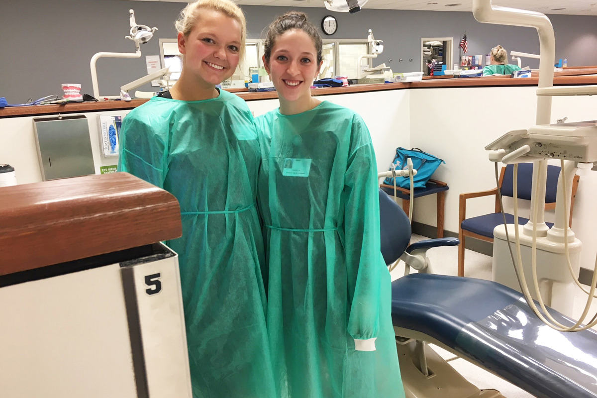 Roommates and dental hygiene students Lindsey Nelson '20 and Hayley Smith '20 take a break during the USI Dental Clinic's Give Back to Veterans Week.