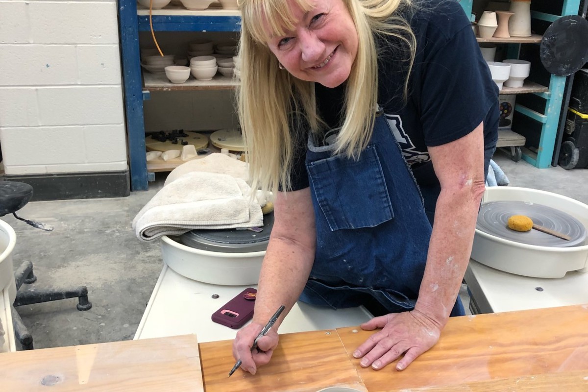 Mary Beth Reese poses while helping with Empty Bowls Evansville