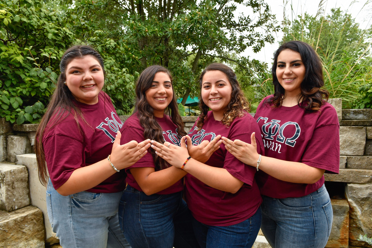 Founding members of USI's Gamma Phi Omega, International Sorority, Inc. pose in David and Betty Rice Plaza on campus.