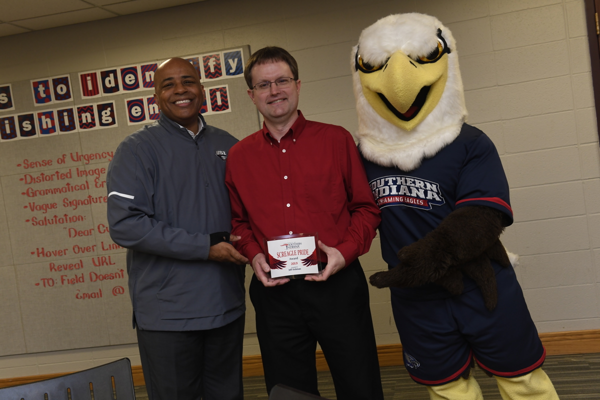 Jeff Sickman (center) poses with President Rochon and Archie after receiving USI's third annual Screagle Pride Award.