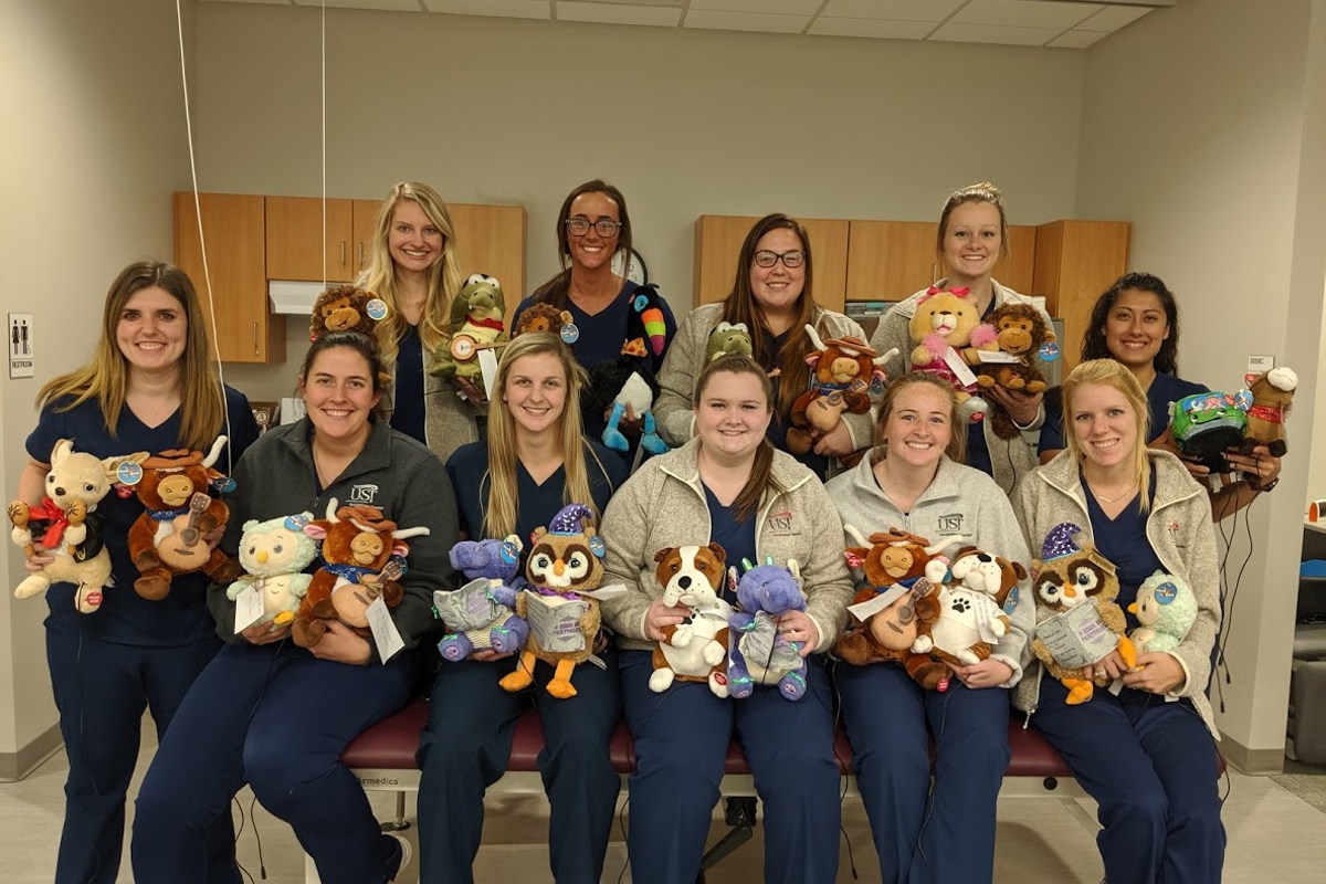 USI occupational therapy and occupational therapy assistant students show the toys they adapted for students in the Warrick County School Corporation.