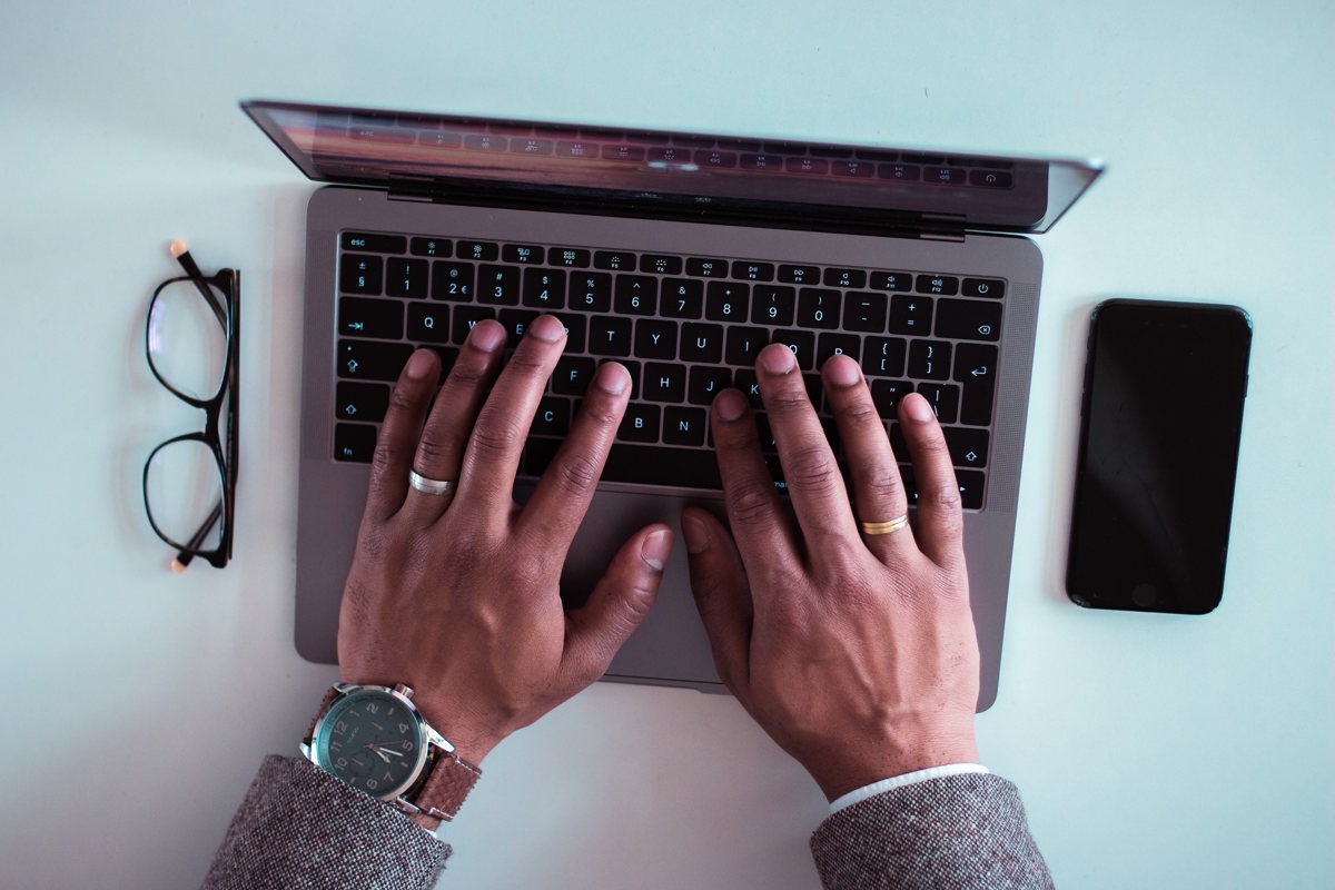 Person's hands on a computer for online learning