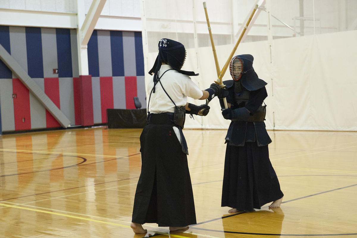 Erina Tamura (right) and another participant demonstrate Kendo at a USI Culture Night event in the Recreation, Fitness and Wellness Center