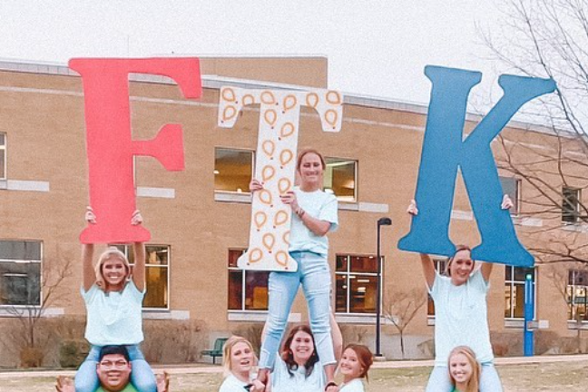 Southern Indiana Dance Marathon student members show off their FTK (For the Kids) letters in front of University Center West on the USI campus.