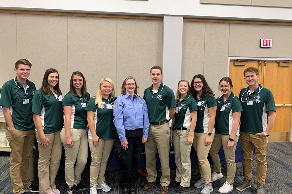 Tami Jaramillo Zuniga, center, poses with USI respiratory therapy students
