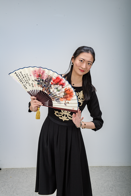 asian woman holding a colorful fan