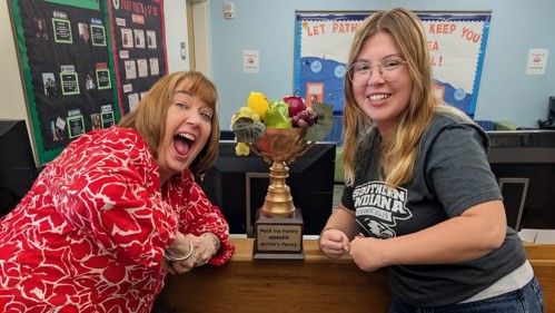 Pack the Pantry Red team members posing with the winner's trophy.