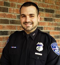 Portrait of Ryan C. Eagleson in uniform in front of brick wall