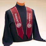 dark red stole with white trim and white Rotaract text and logo on each side
