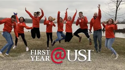 USI team jumping for joy, with the words "First Year @ USI" overlaid