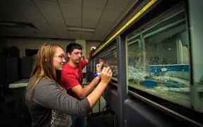 Engineering students work together to complete a project in the engineering lab