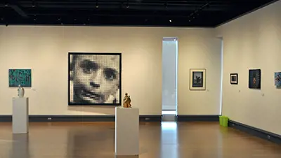 Photo of sculptures and 2D art on walls.