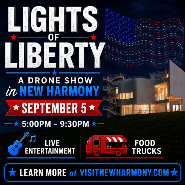 Promotional graphic for “Lights of Liberty: A Drone Show in New Harmony.” Large white and blue text appears against a dark blue night sky. A red, white, and blue drone-formed American flag flies above a modern, illuminated building. Event details read: “September 5,” “5:00 PM–9:30 PM,” with icons and text highlighting “Live Entertainment” and “Food Trucks.” A banner at the bottom says, “Learn More at VisitNewHarmony.com.” The design uses patriotic red, white, and blue colors throughout.