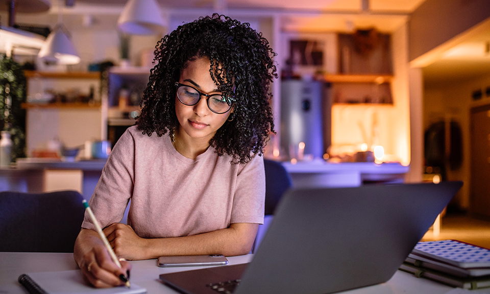 Female studying with laptop in evening