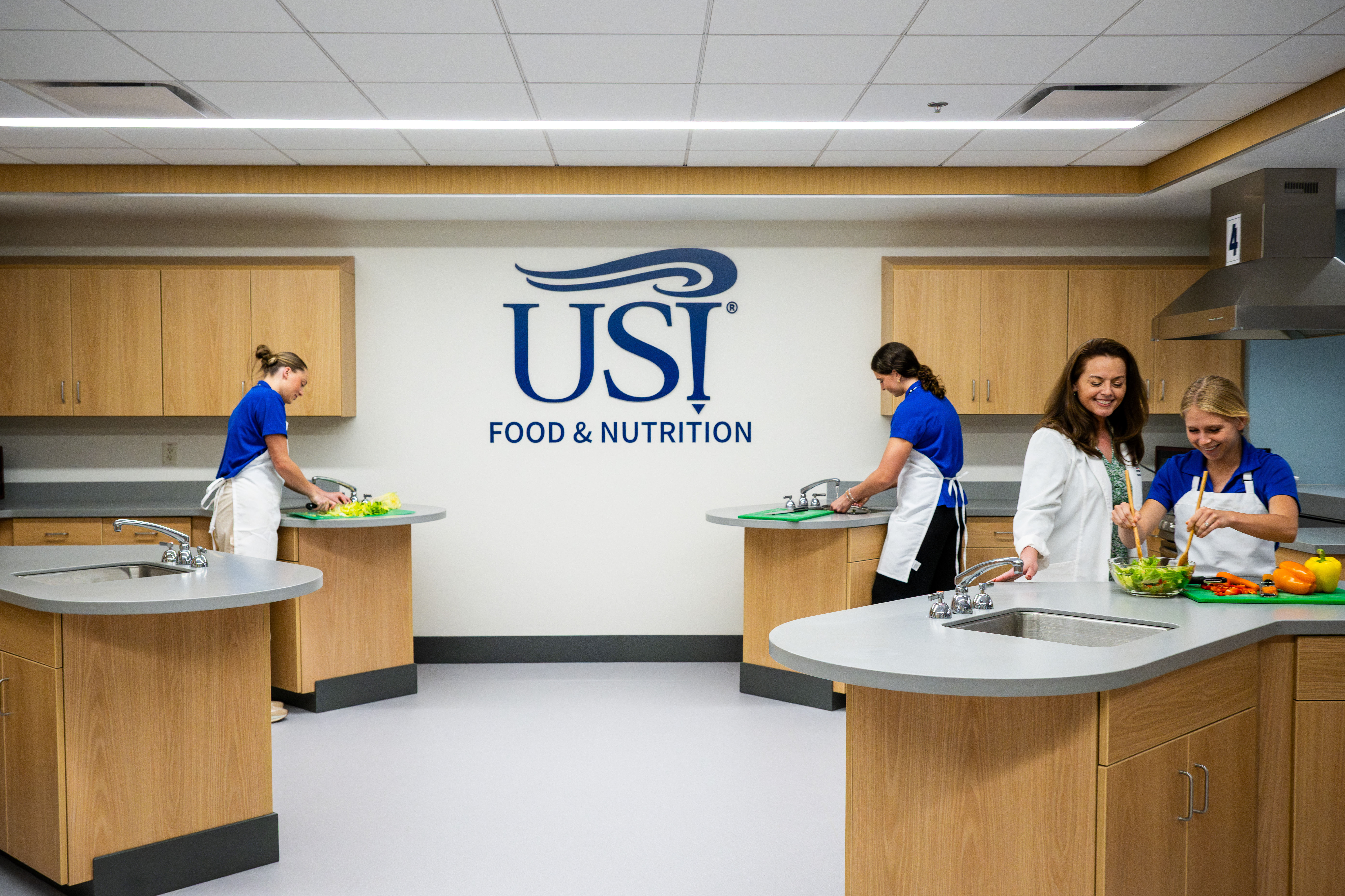 Students and faculty prepare meals in the USI test kitchen