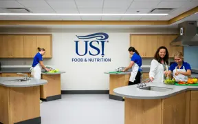 Students and faculty prepare meals in the USI test kitchen