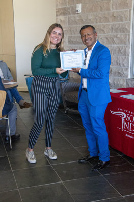 Sudesh handing Gracie her certificate