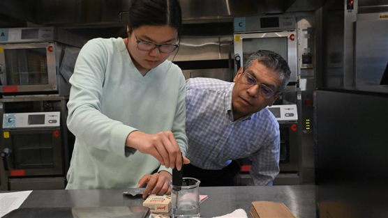 USI student and faculty working in a food science lab