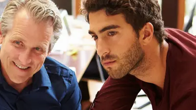 Older adult and younger adult work on a project together