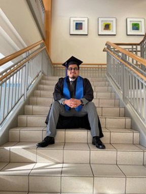 Portrait of Carlos Cruz sitting on stairs