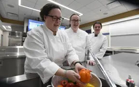 Students and faculty wash vegetables in the test kitchen