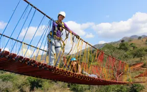USI engineering students stand on the suspension bridge the built as part of Engineers in Action