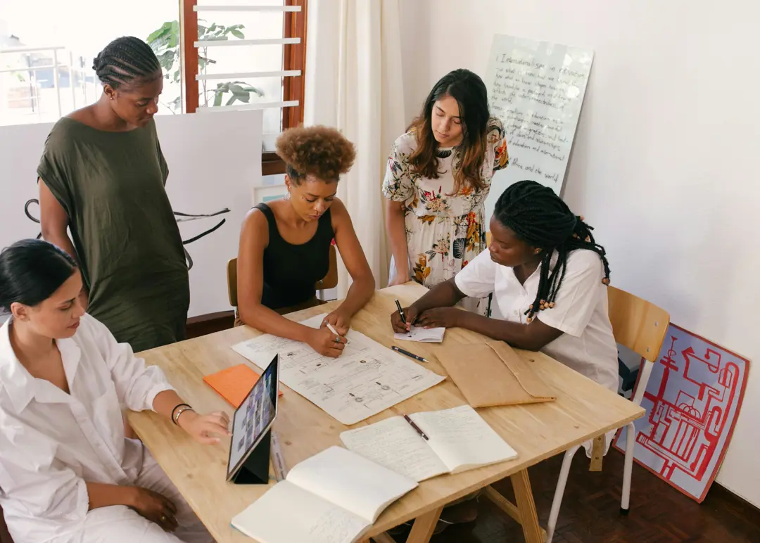 Diverse group of professionals working around a table on a project
