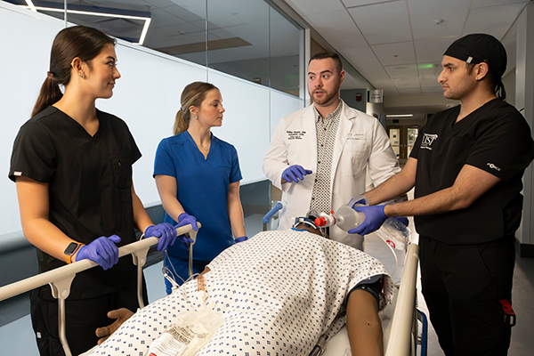 Nurse walking down hallway with students