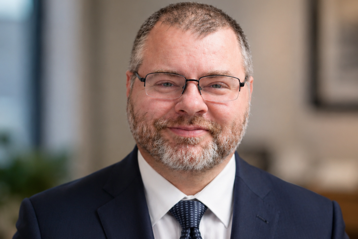Professional headshot of Matthew Brown, the new Director of Technical Services at USI. Brown is smiling with a traditional professional background behind him.
