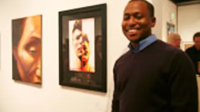 DeWayne Esson, senior graphic design student, with his work