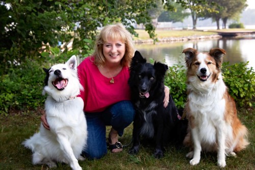 woman with three dogs