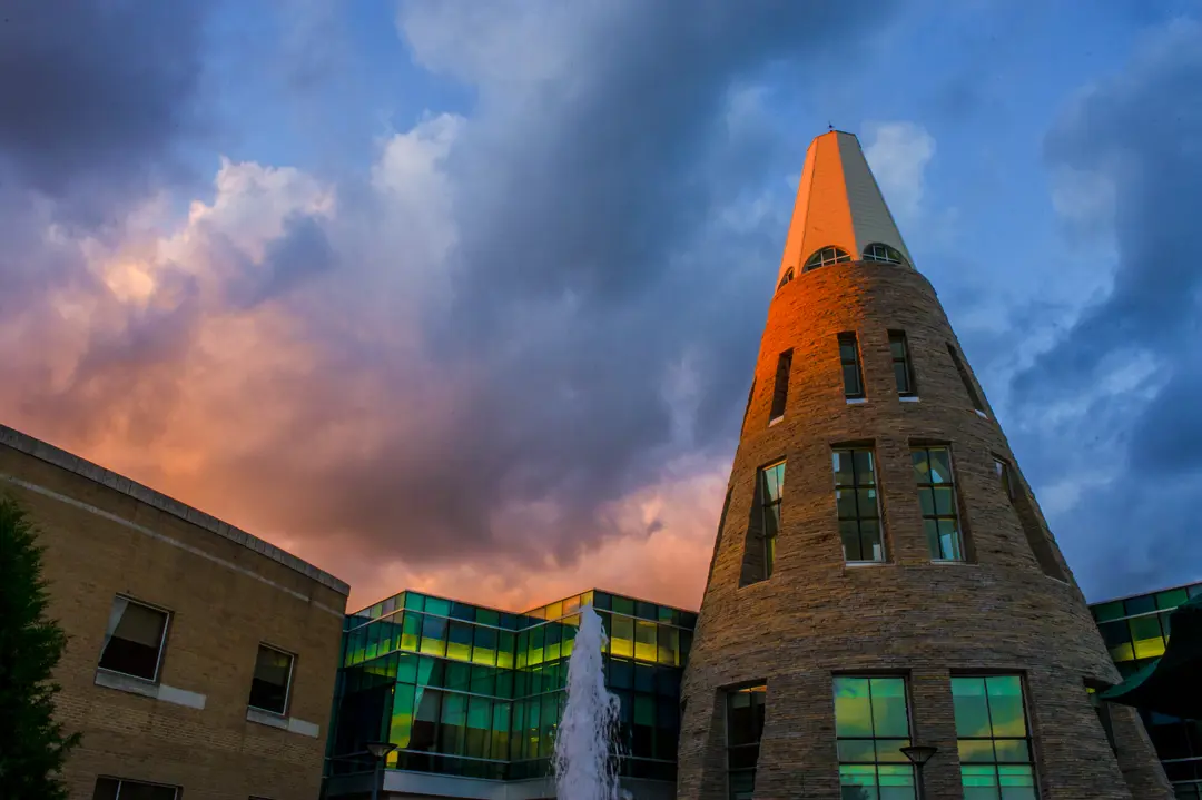 Exterior view of the University Center Tower at dusk from a low angle