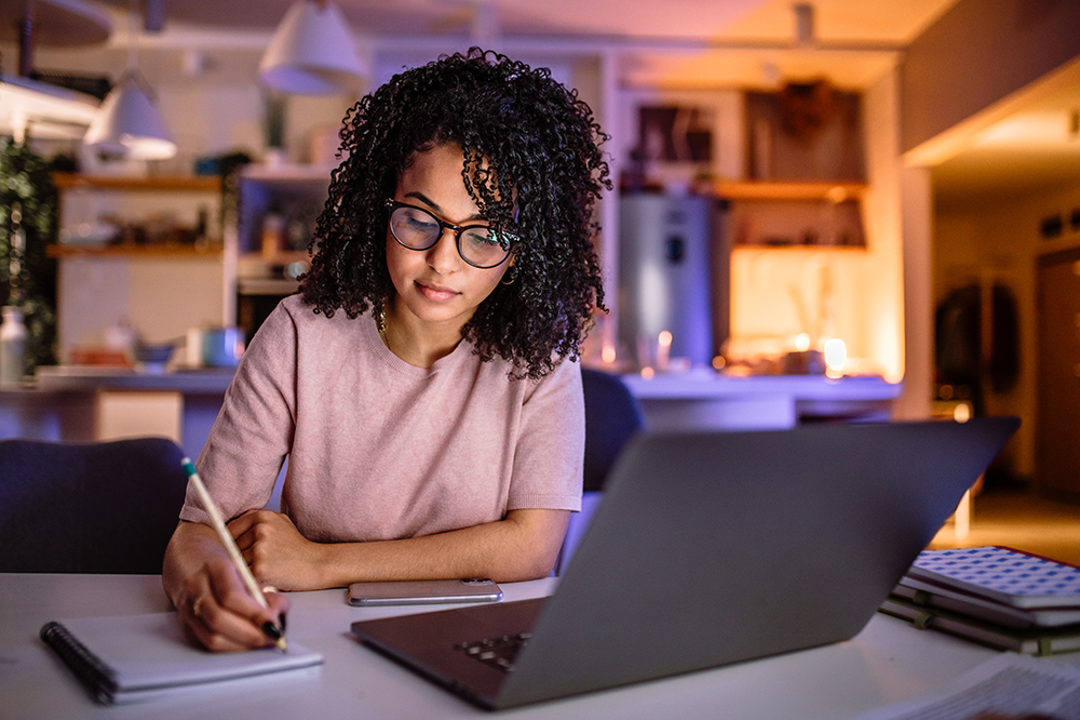 Female studying with laptop in evening