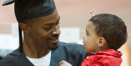 graduating father and young son