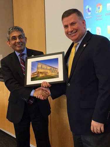 Dean Mohammed Khayum presents Hammett with a framed photo.