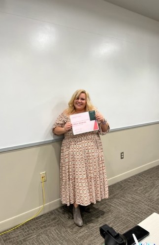 Alice Graves posing with award at the English Awards Day Potluck
